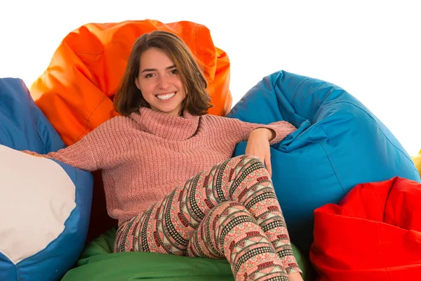 Jovem mulher feliz sentada entre cadeiras de saco de feijão — Fotografia de Stock