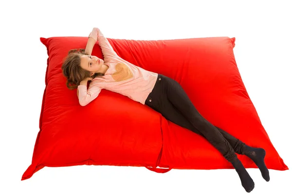 Dreaming girl lying on red beanbag sofa for living room or other — Stock Photo, Image