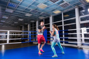 Young athletic male and female in action practicing boxing clipart