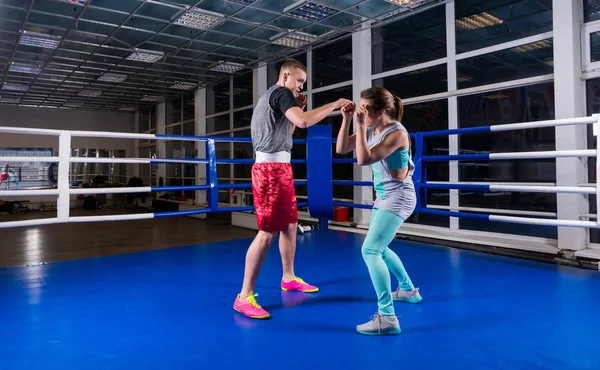 Young athletic male and female in sportswear in action practicin — Stock Photo, Image