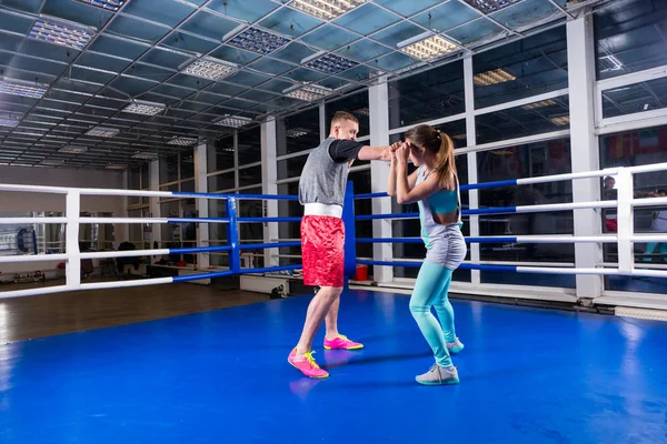 Athletic male and female in sportswear practicing boxing in regu — Stock Photo, Image