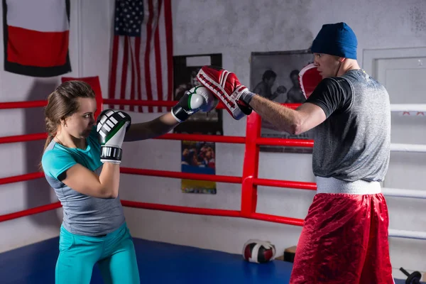 Young adult woman doing kickboxing training with her coach — Stock Photo, Image