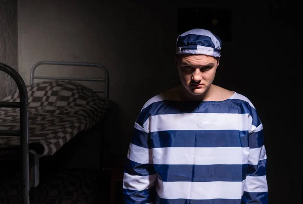 Malvagio maschio prigioniero indossare prigione uniforme in piedi in un piccolo — Foto Stock