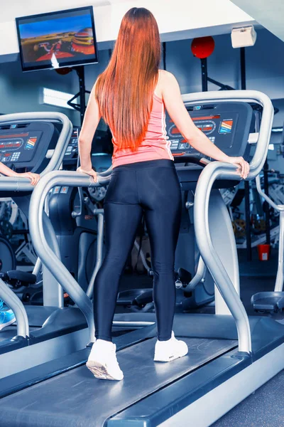 Rear view of young fit woman exercising on a treadmill — Stock Photo, Image