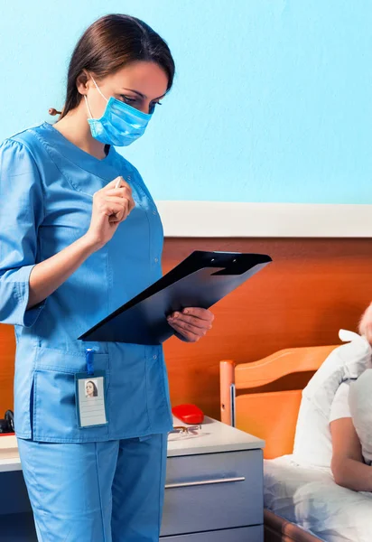 Klibi de arıyorsunuz bir maske takarak üniformalı genç çekici hemşire