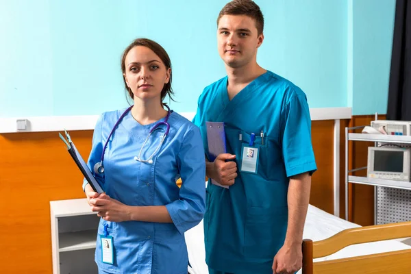 Portrait of male and female doctor in uniform with phonendoscope — Stock Photo, Image