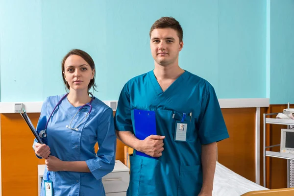 Portrait of young male and female doctor in uniform with phonend — Stock Photo, Image