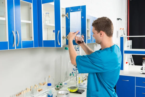 Young male scientist in uniform is — Stock Photo, Image