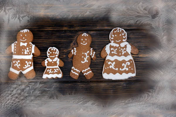 Adorable homemade gingerbread on dark wooden background with sno — Stock Photo, Image