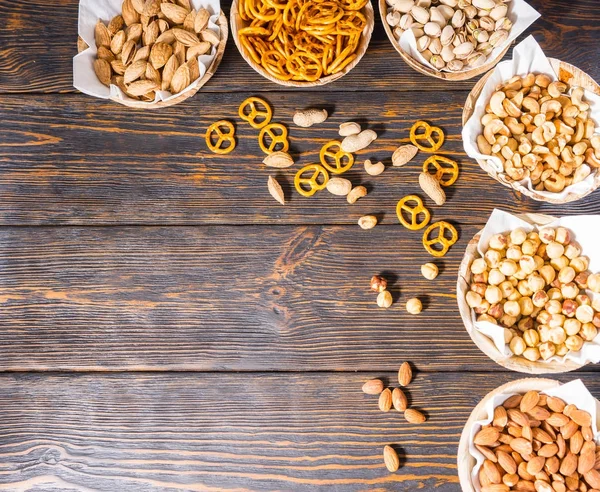 Top view of various beer snacks in plates like pistachios, small — Stock Photo, Image