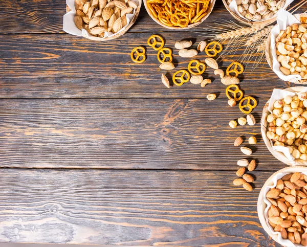 Top view of various beer snacks in plates like pistachios, small — Stock Photo, Image