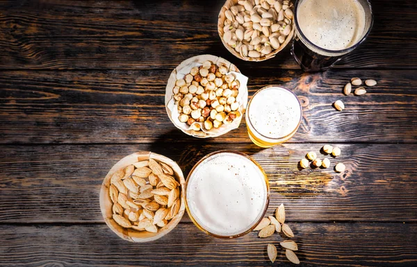 Top view of three glasses with light, unfiltered and dark beer s