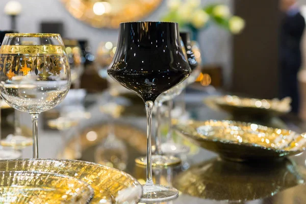 Close up of black and with a golden rim luxurious glasses near p — Stock Photo, Image