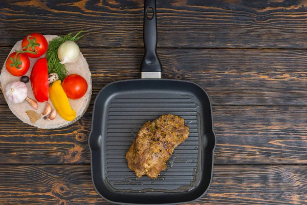 High angle view of prepared meat on a grill pan next to vegetabl — Stock Photo, Image