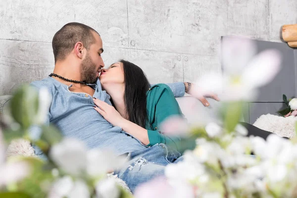 View from flowers on beautiful international couple of man with — Stock Photo, Image