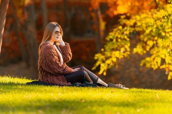Attraktive, stylische junge Frau entspannt in einem Park — Stockfoto