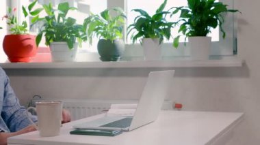 Businessman typing in data on a laptop