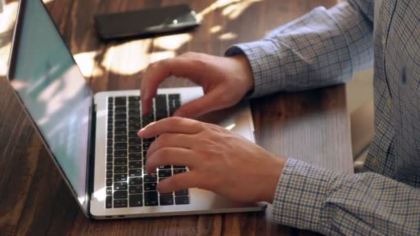 Man inputting data on a laptop computer — Stockvideo