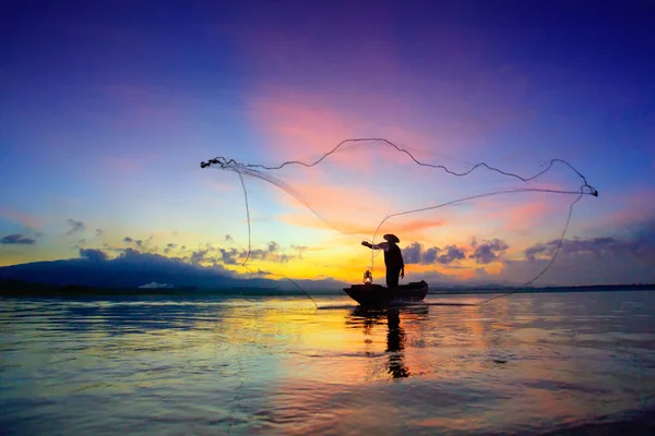 Silhouette of fishermen using nets to catch fish — Stock Photo, Image