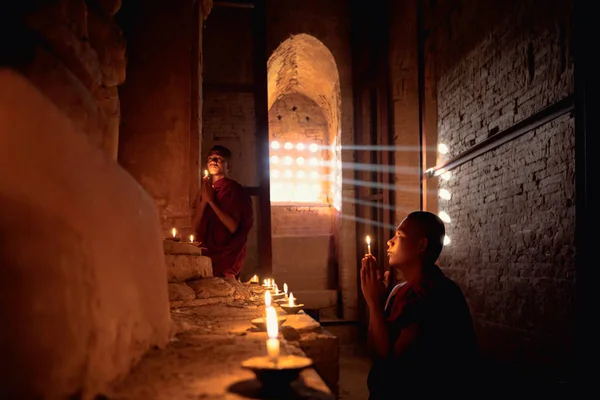 Novices praying with candles — Stock Photo, Image