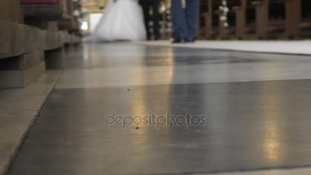 Newlyweds walking church aisle blurred — Stock Video