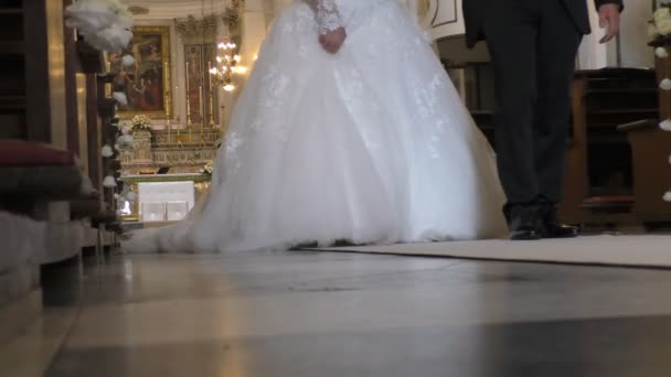 Jonggehuwden lopen naar de kerk verlaten deur — Stockvideo