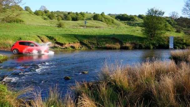 Side View Small Car Driving Shallow Water Stream Making Big — Stock Video