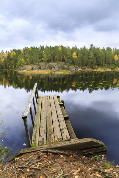 Old wooden bridge in a lake in autumn — Stock Photo, Image