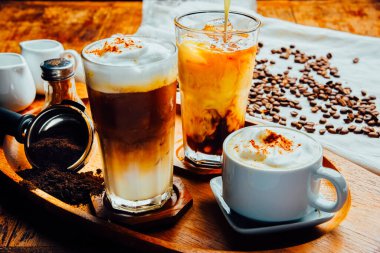 Kahve, kapuçino, siyah espresso ve sehpanın üzerinde kahve çekirdekleri olan cam koleksiyonu, içecek menüsü. kafe resmi