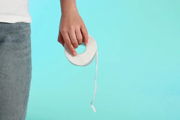 Rolo de papel higiênico branco na mão feminina, vista frontal — Fotografia de Stock