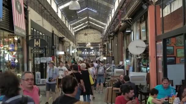 The main hall of San Telmo Fair full of tourists shopping antiques. DOLLY IN — Stock Video