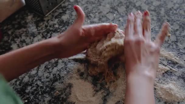 Woman kneading whole wheat dough with circular movements on floured countertop — 비디오