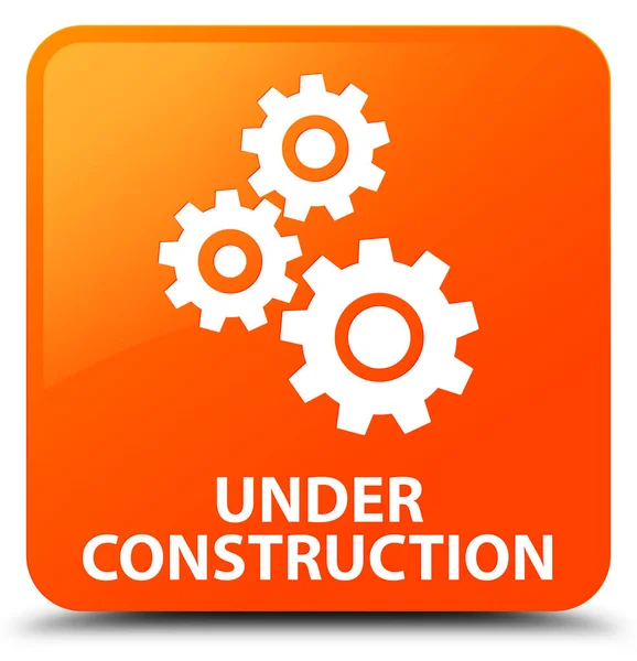 Im Bau (Schaltgetriebe-Symbol) orangefarbener quadratischer Knopf — Stockfoto