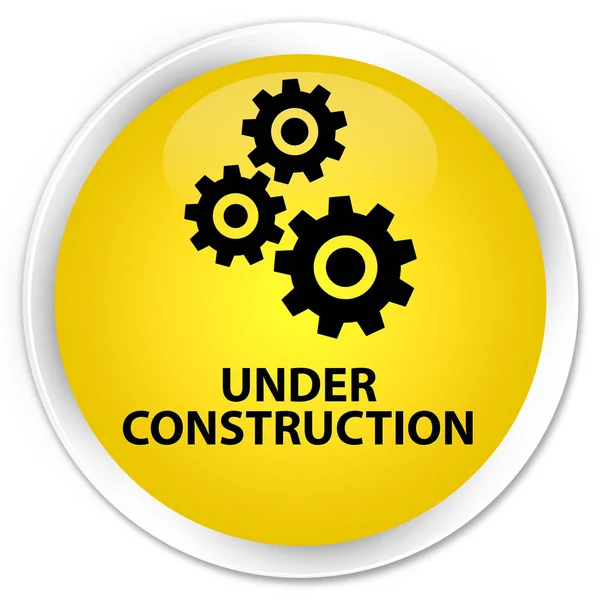 Em construção (ícone de engrenagens) botão redondo amarelo prémio — Fotografia de Stock