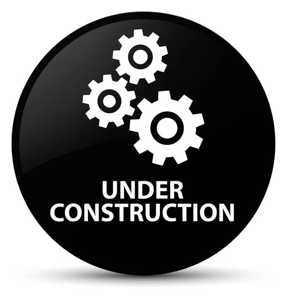 En construcción (icono de engranajes) botón redondo negro — Foto de Stock