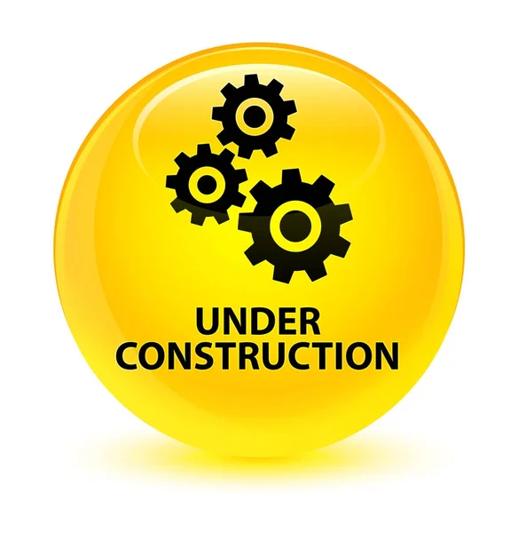 Under construction (gears icon) glassy yellow round button — Stock Photo, Image