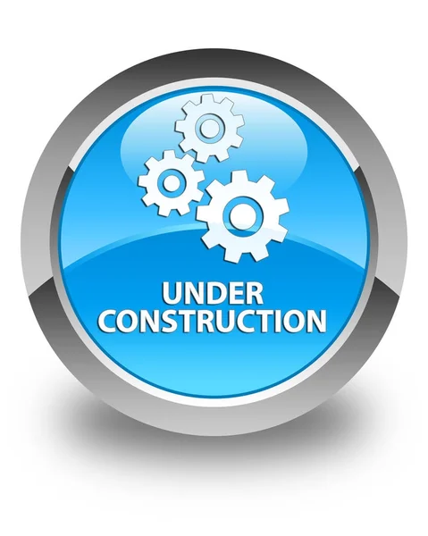 Under construction (gears icon) glossy cyan blue round button — Stock Photo, Image