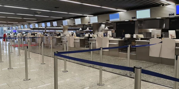 Empty check-in counters with computers, monitors, luggage scales, drop off counters. The concept of the transition to the online check-in and reducing staff at airports. Empty airport. No people.