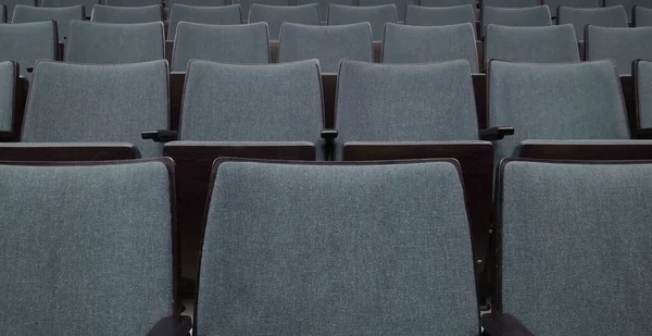 Empty rows of seats in auditorium or concert hall.Close up,selective focus. Concept of quarantine,curfew,cancellation of mass events to prevent coronavirus,losses of organizers in entertainment sector
