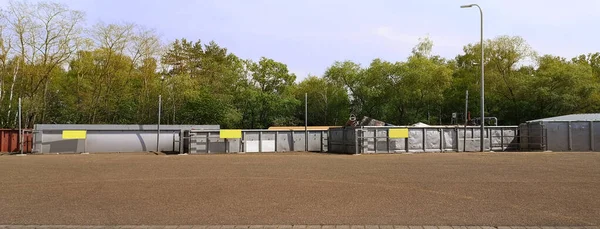 Few huge metal containers on station of collection of large-size garbage for sorting of old furniture,wood,metal,household waste.Point of bulky waste reception and separation.Horizontal banner.Mockup — Stock Photo, Image