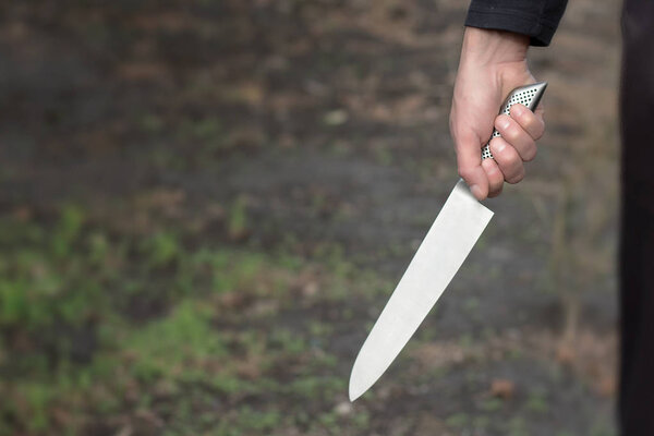 The man with a knife in a hand. Closeup