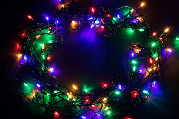 Christmas garland lights on darck background — Stock Photo, Image