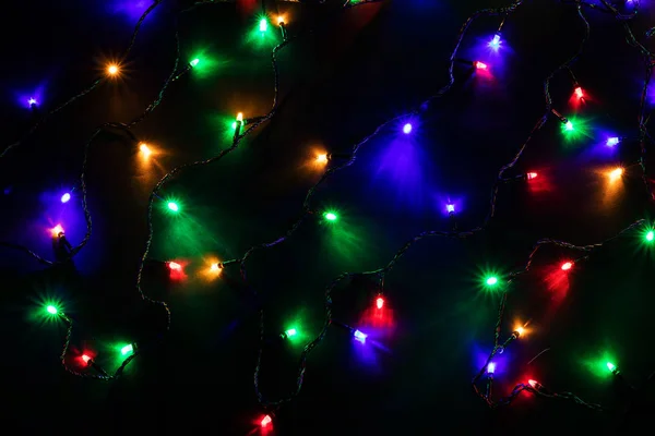 Christmas garland lights on darck background — Stock Photo, Image