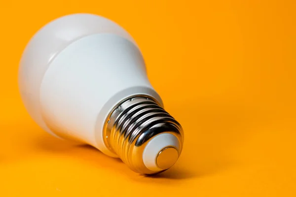 LED, New technology light bulb on yellow background, Energy super saving electric lamp is good for environment.