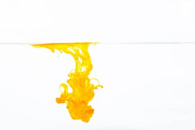 Orange ink drop in water, abstract orange ink in water on white background