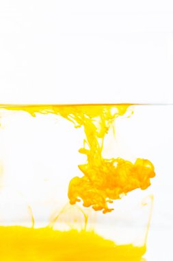 Orange ink drop in water, abstract orange ink in water on white background
