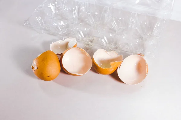 Broken egg isolated on white background, broken egg shell from impact