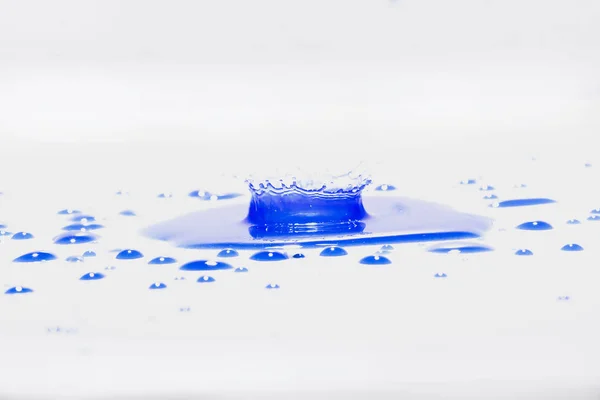 Blue water splashes On a white background, Photography. Blue water splashes.