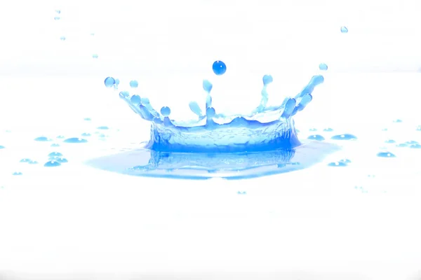 Blue water splashes On a white background, Photography. Blue water splashes.