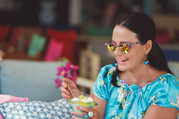 Красивая женщина ест десерт в ресторане на открытом воздухе, избирательный фокус — стоковое фото